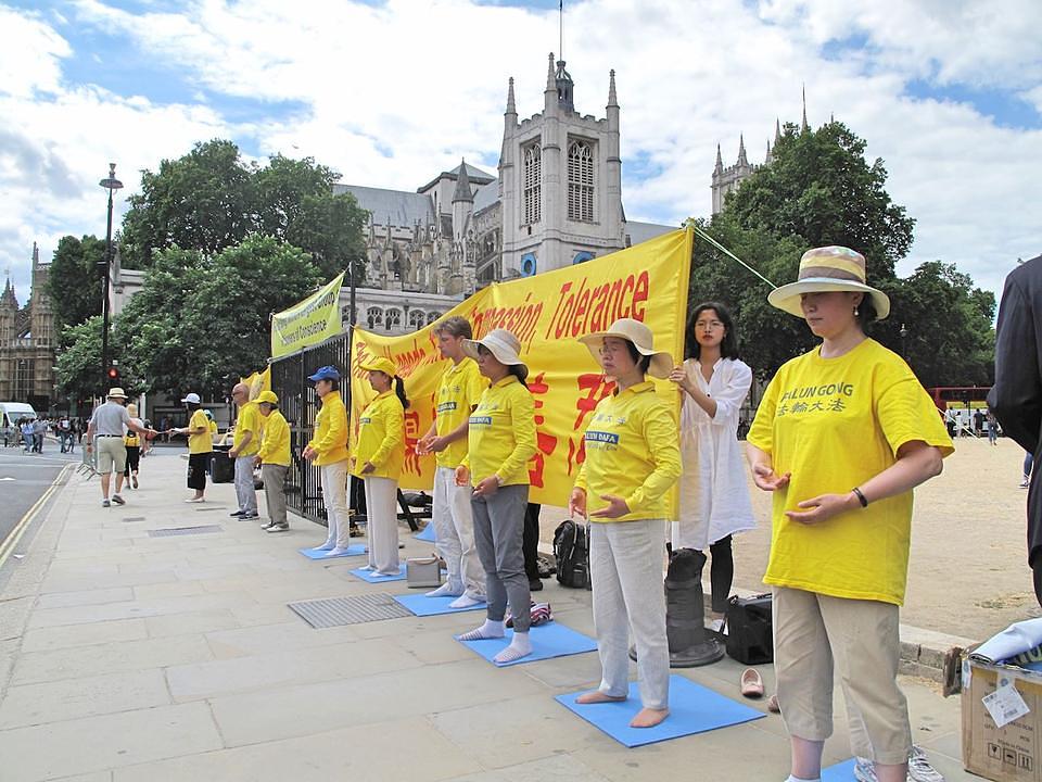 Falun Gong praktikanti su demonstrirali vežbe, razgovarali sa prolaznicima o progonu u Kini i sakupljali potpise kako bi zaustavili progon, tokom mirnog protesta u blizini britanskog parlamenta. 