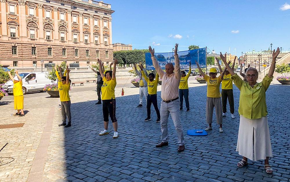 Praktikanti na Mynttorgetu u Stockholmu informišu prolaznike o progonu Falun Gonga u Kini od strane KPK.