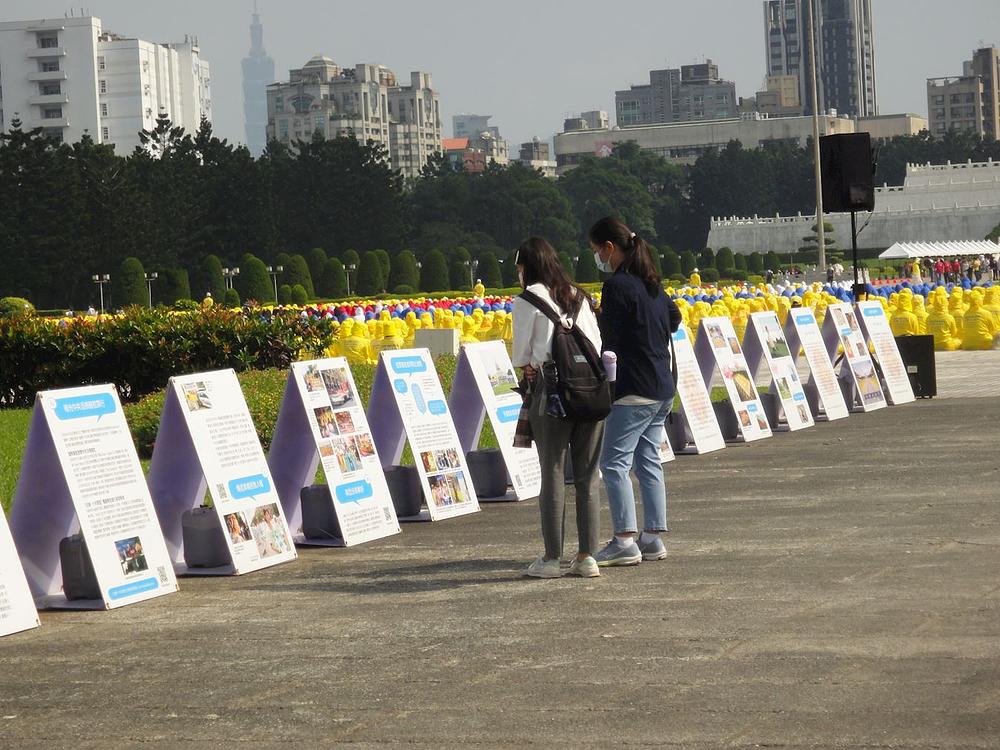 *Turisti i lokalni stanovnici se zaustavljaju da bi pročitali prikazane informacije i saznali više o Falun Dafa.* 