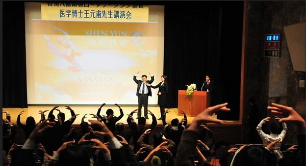 Dr. Wang demonstrira izvođenje vježbi dok ga mnogi slijede, tokom govora održanog u Tokiju 14. januara 2012. godine.
 