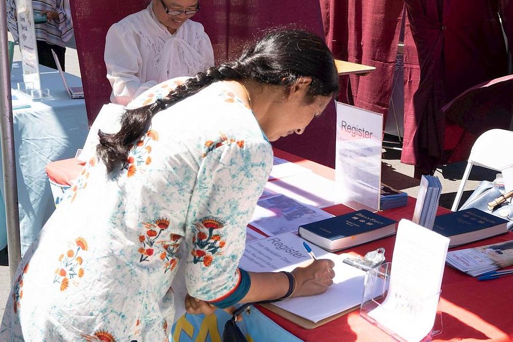 Ljudi se prijavljuju na besplatnu Falun Gong radionicu 